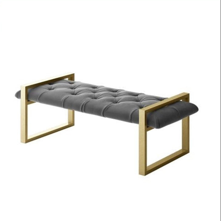 Gray upholstered bench with gold frame on a white background