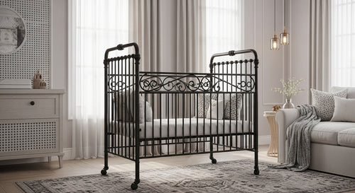 Decorative black crib in a stylish living room with a sofa and side table.