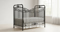 Vintage-style iron crib in a bright room with white bedding