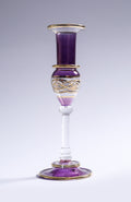Decorative glass vase with purple and gold accents on a white background