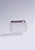 Clear glass vase with textured design and purple rim on a light gray background