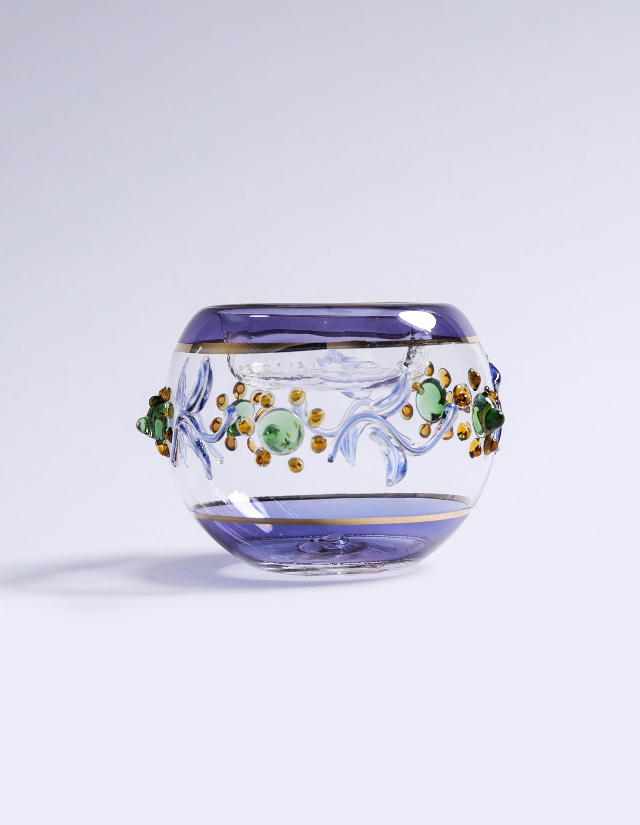 Decorative glass bowl with floral patterns on a light gray background