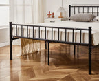 Black metal bed frame with white bedding in a bedroom setting.