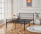 Black metal bed frame in a room with wooden flooring and a window.