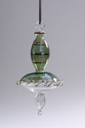 Glass hanging ornament with green and clear sections on a gray background