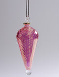 Pink and white glass ornament on a gray background