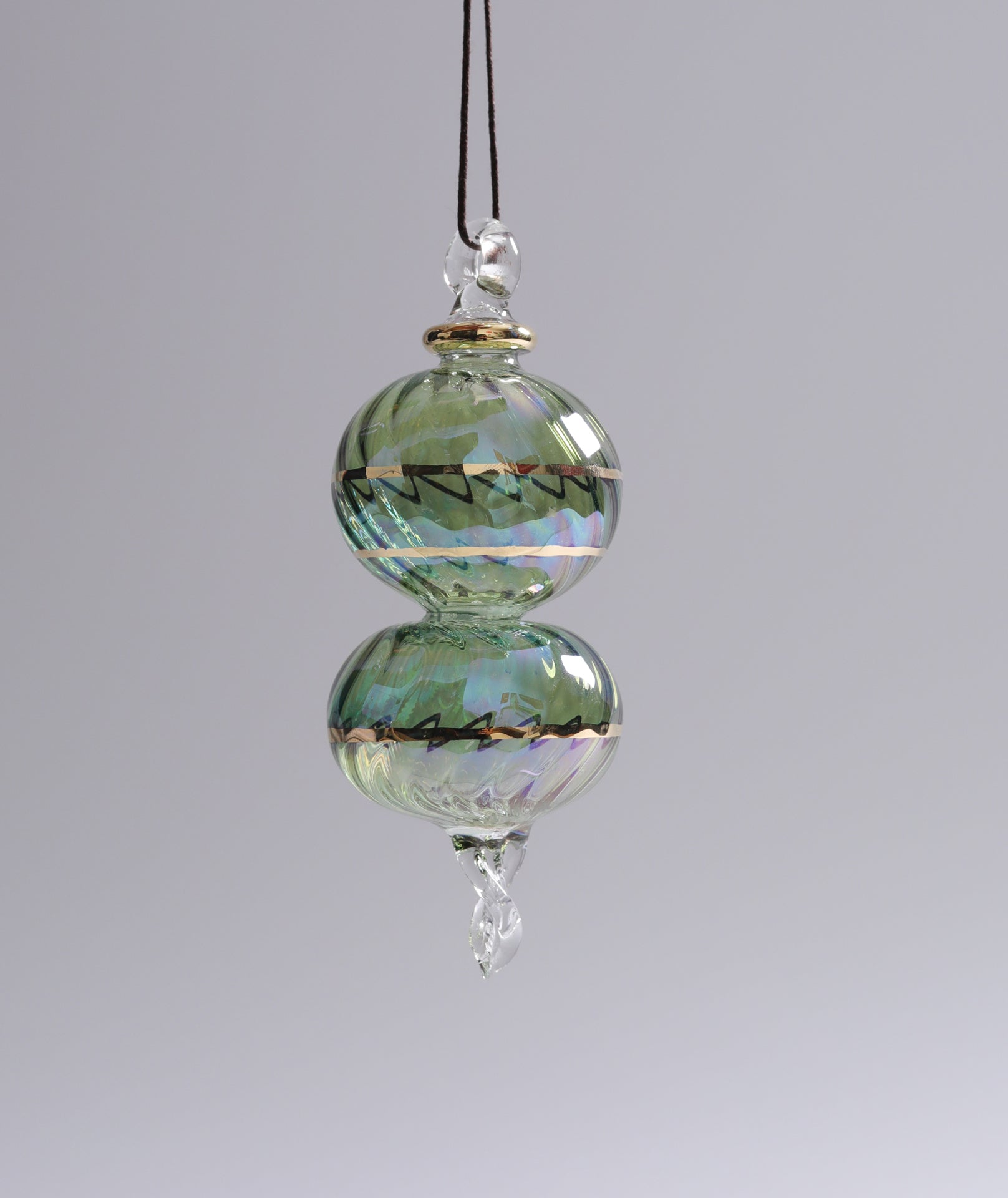 Decorative glass hanging ornament on a plain background