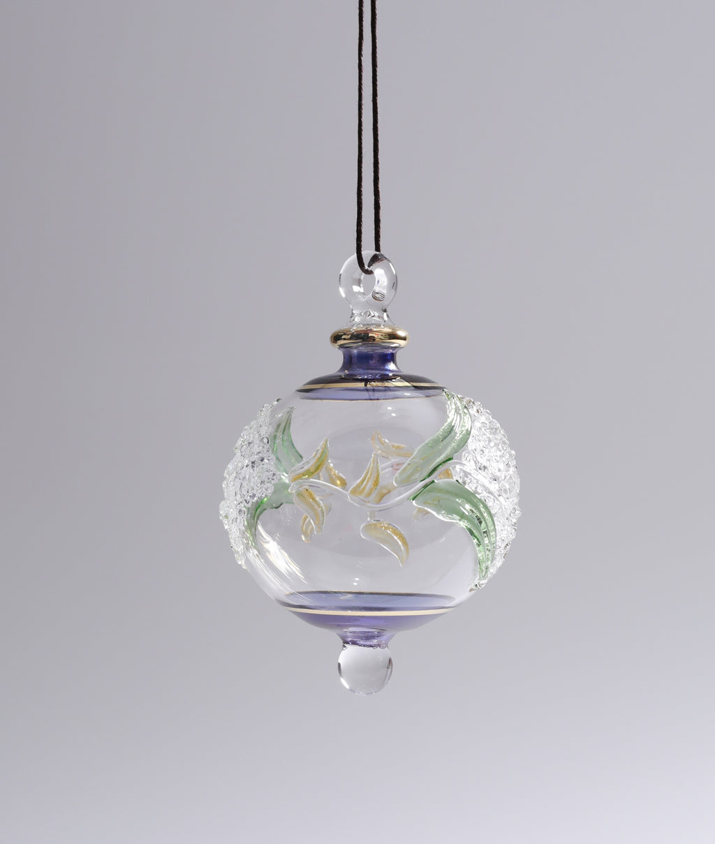 Decorative glass hanging ornament with floral design on a plain background