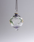 Decorative glass hanging ornament with floral design on a gray background