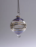 Decorative glass ornament with purple and gold accents on a gray background