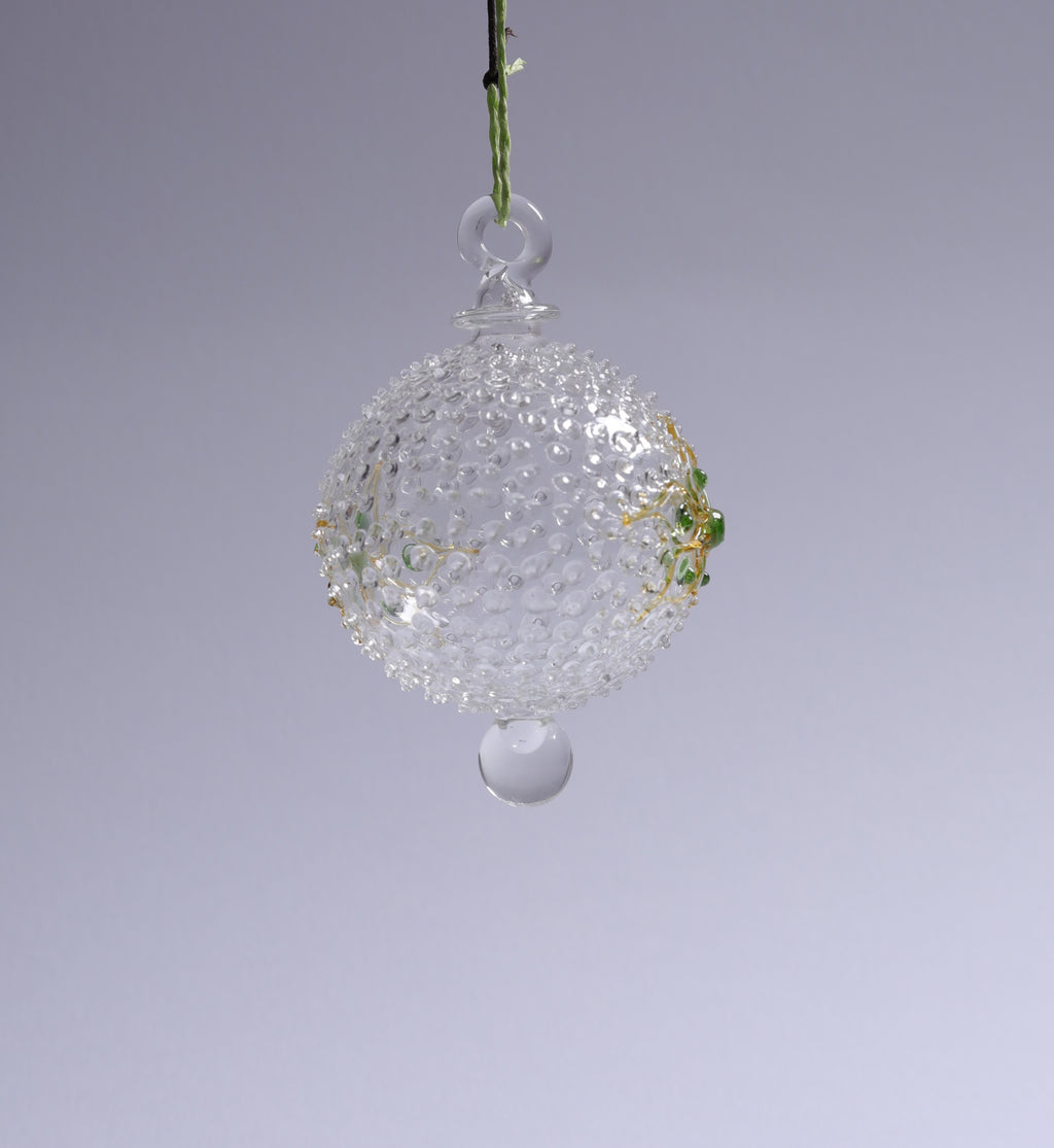 Decorative glass ball hanging against a gray background