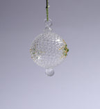 Decorative glass ball hanging against a gray background