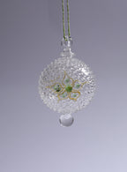 Decorative glass ball with plants on a gray background