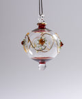 Decorative glass ornament with floral design on a plain background
