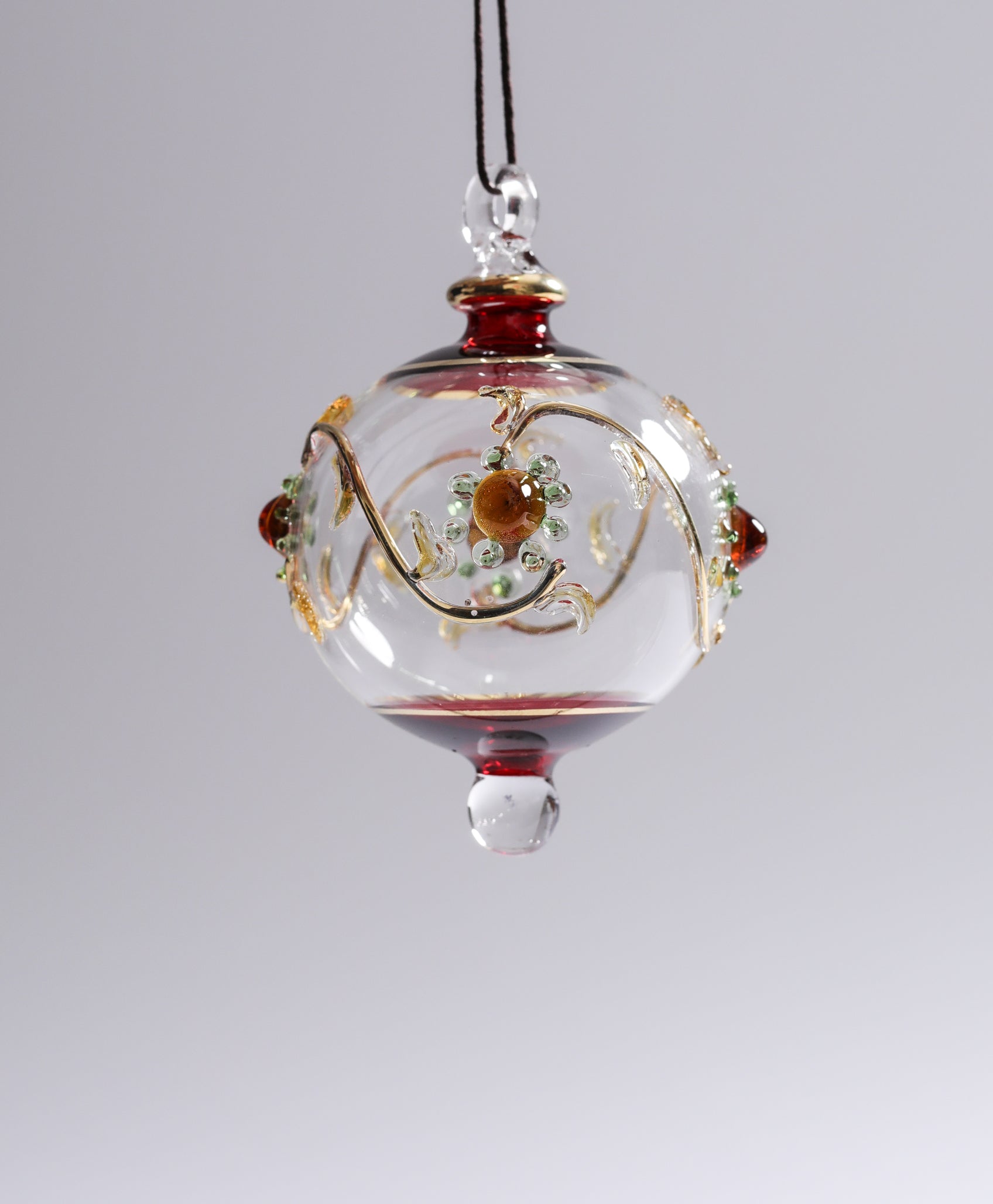 Decorative glass ornament with floral design on a plain background