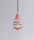 Decorative hanging glass ornament with pink and gold design on a gray background