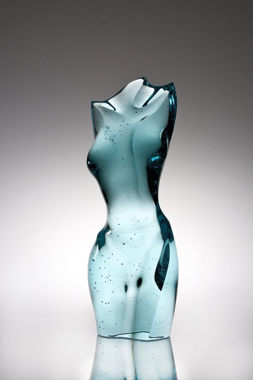 Glass sculpture of a torso on a gray background
