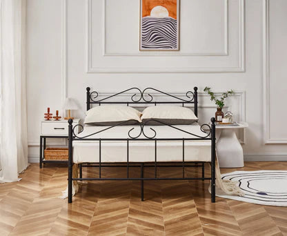 Wrought iron bed with white mattress in a bedroom setting