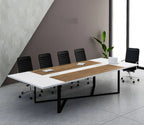 Modern office conference table with chairs and a plant in a minimalistic room.