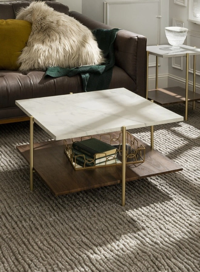 Coffee table with marble top and gold legs in a living room setting
