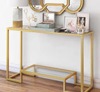 Gold console table with decorative items against a white wall