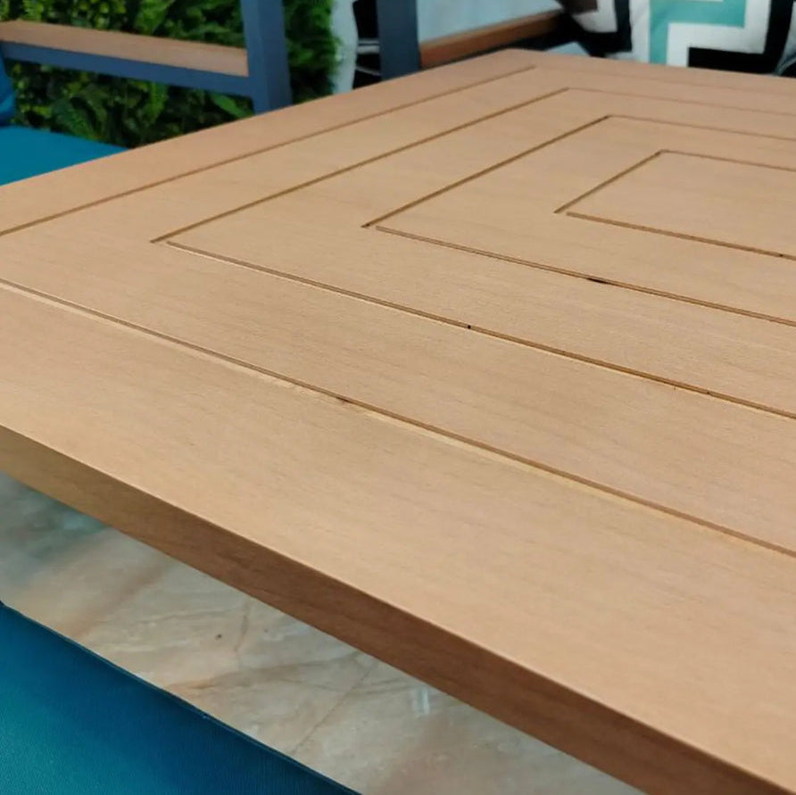 Wooden table with a geometric pattern on a blurred outdoor background