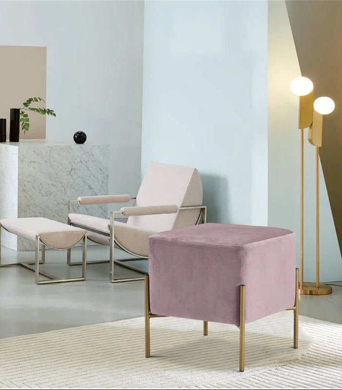 Modern living room with a pink ottoman and white armchair.