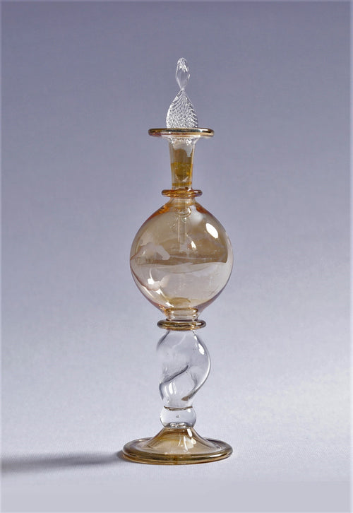 Glass decanter with a spiral design on a gray background