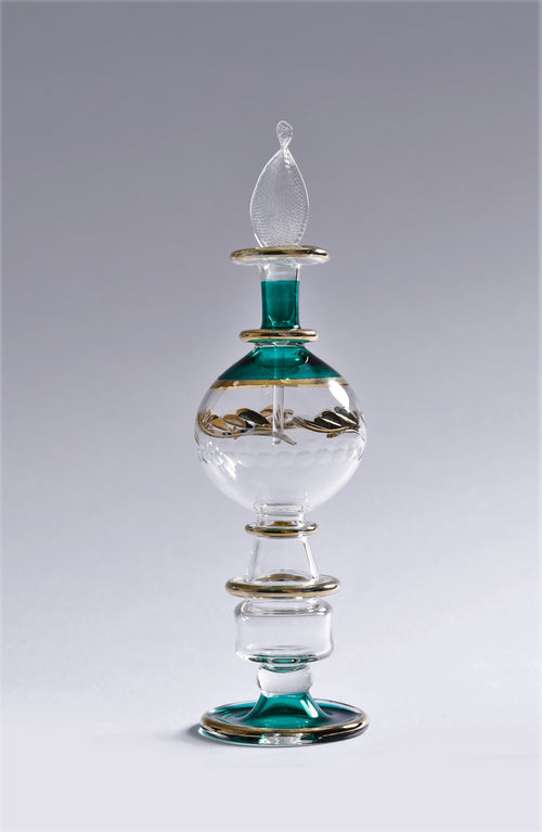 Decorative glass bottle with green accents on a gray background