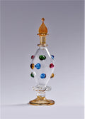 Decorative glass bottle with colorful gemstones on a gray background