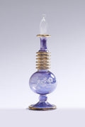 Decorative glass bottle with intricate design on a white background