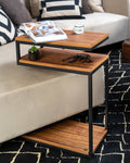 Wooden side table with magazine and cup on a sofa
