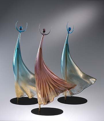 Three abstract sculptures with flowing forms on a gray background