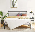 Bedroom with a bed, pillows, and a lamp on a nightstand.
