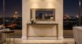 Decorative console table with mirror against a cityscape at night