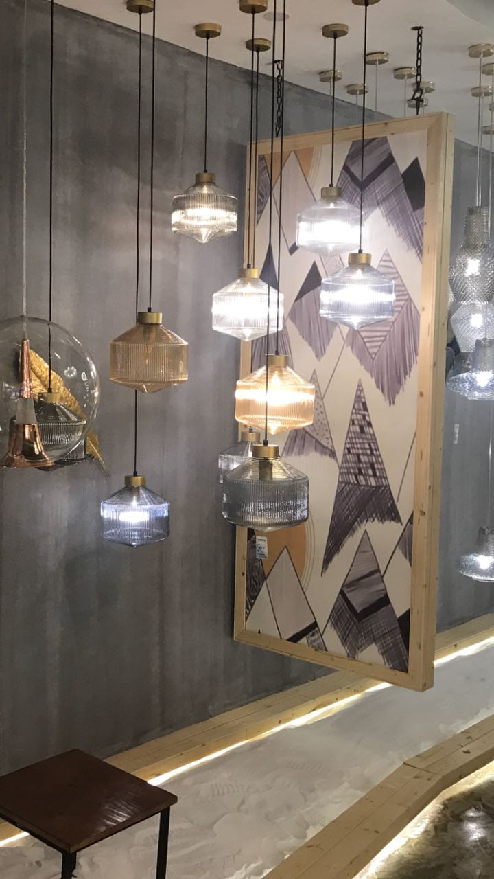 Modern interior design with hanging pendant lights and abstract wall art.