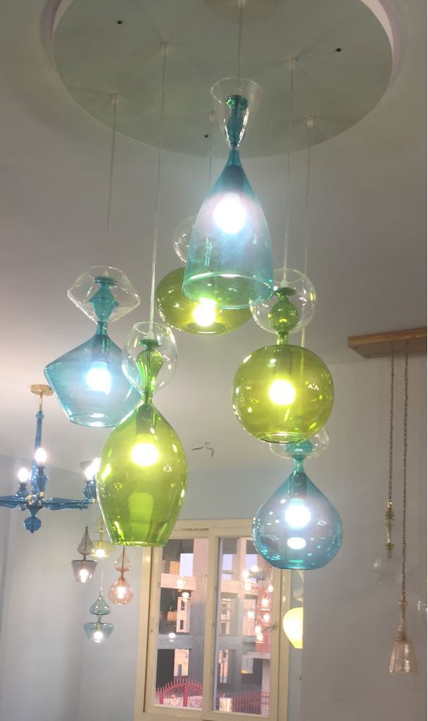 Colorful glass pendant lights hanging from a ceiling