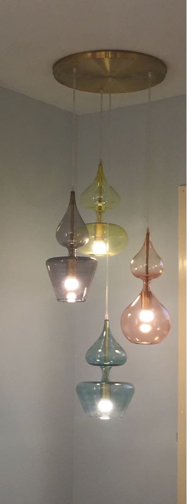 Colorful glass pendant lights hanging from a ceiling