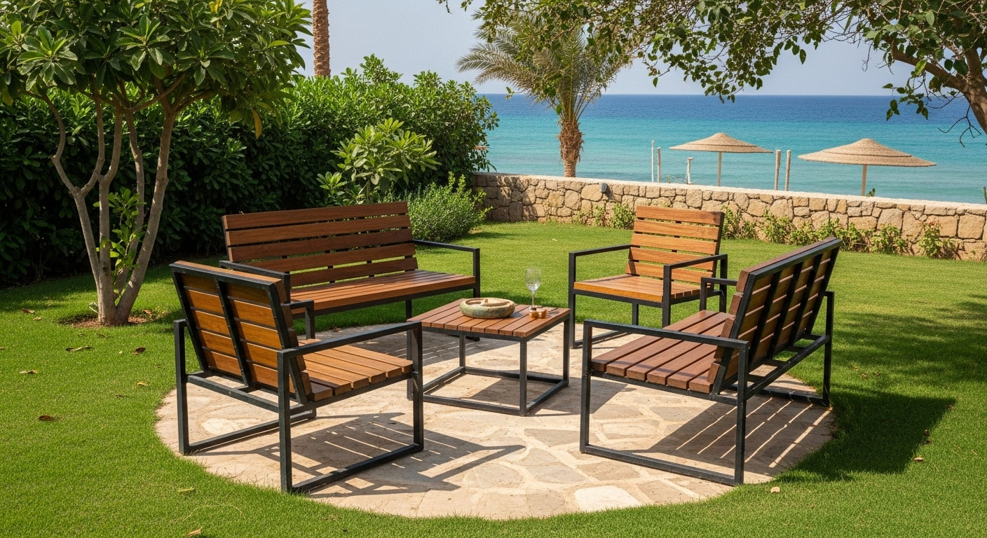 Outdoor patio set with wooden chairs and table on a grassy area near a body of water.