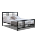Black metal bed frame with white bedding and gray blanket on a white background