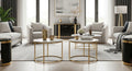 Modern living room with gray sofas, gold coffee tables, and decorative items.