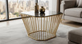 Modern coffee table with gold metal frame and black glass top in a living room setting.