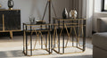 Modern gold and black side tables in a living room setting.