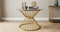 Gold wireframe side table with decorative items on a wooden floor.